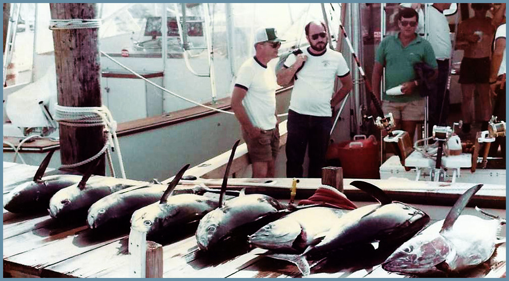 Several fishermen in fishing shirts and fishing hats eyeing their catch